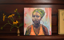 Load image into Gallery viewer, Portrait of Nina Simone, 12 x 12 oil painting on 2.5&quot; deep canvas. Photo includes the painting on the artist, Honey Hilliard&#39;s piano with a small brass vase of black eyed Susan flowers.